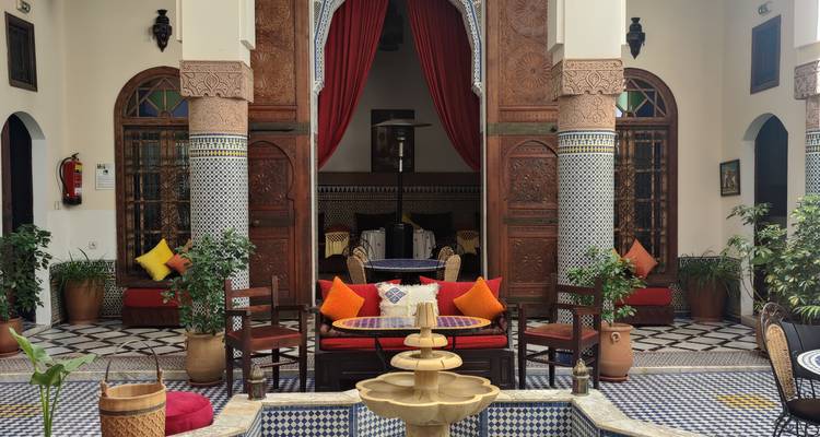 Traditional Moroccan interior decor with a central fountain.