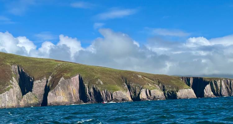 Dramatic cliffs with blue sea and sky.