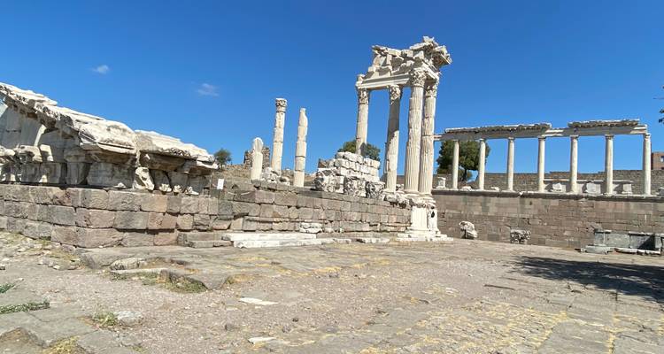 Ancient ruins and columns under a clear blue sky.