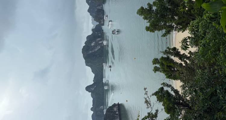 Halong Bay view with boats and limestone islands.