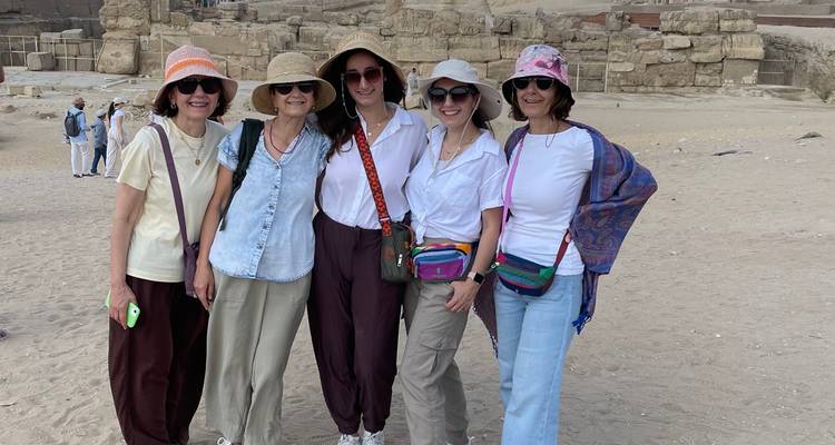 Group of women posing in front of ancient ruins.