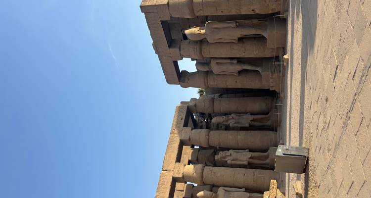 Ancient temple ruins with tall columns and statues.