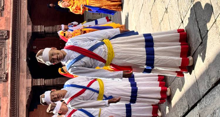 Group of people in traditional attire performing a dance.