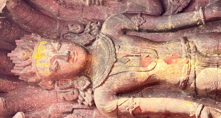 A colorful, intricate stone statue with gold detailing.