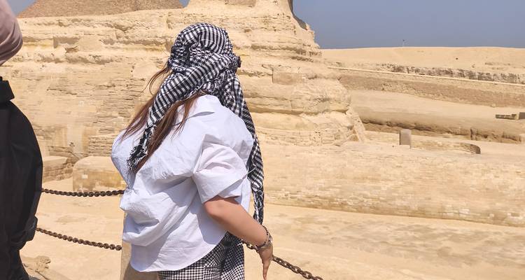 Woman in headscarf looking towards the Sphinx.