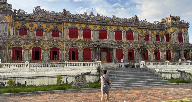 A historic building with intricate architecture and a person walking past.