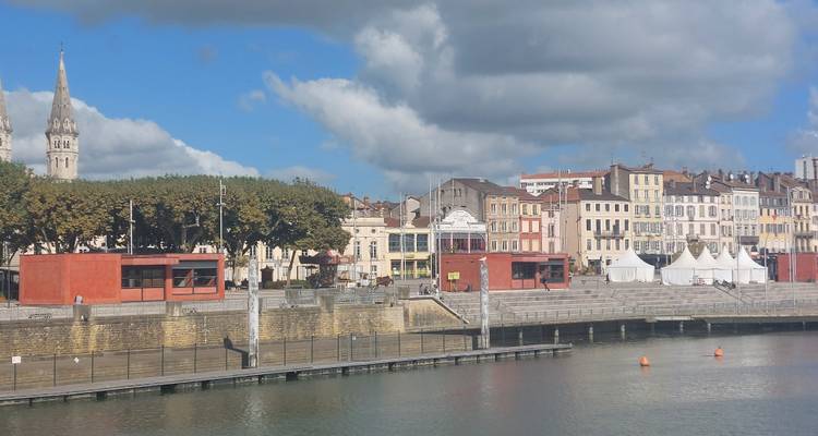 Riverside town with a row of colorful buildings.