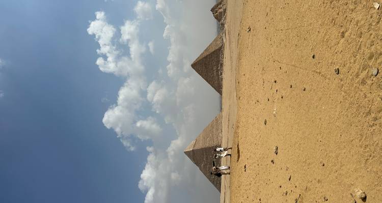 The Great Pyramids of Giza surrounded by desert landscape.