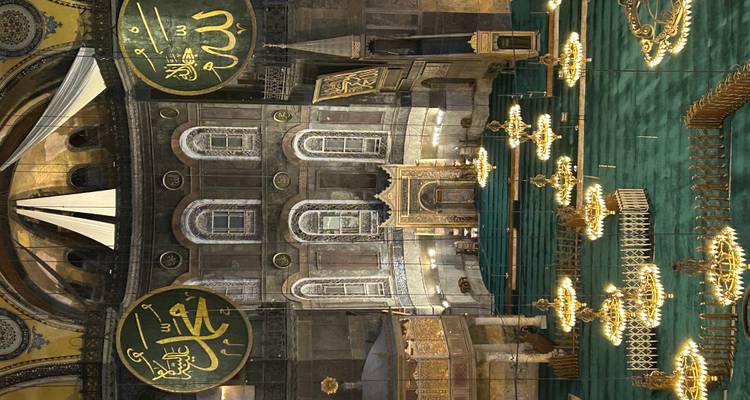 Interior of famous mosque with ornate decorations and chandeliers.