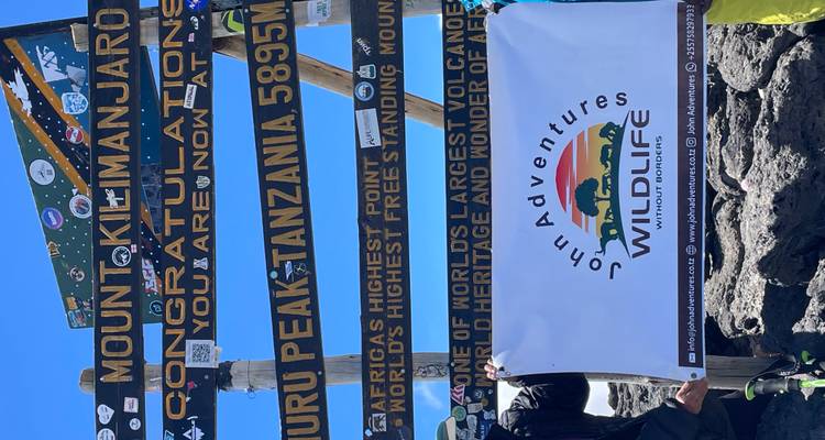 Summit signposts at Uhuru Peak, Mount Kilimanjaro.