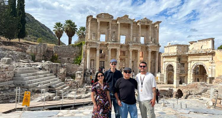 Group of people posing in front of the Library of Celsus ruins.
