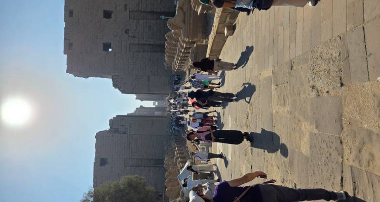 Tourists walking towards the Karnak temple complex.