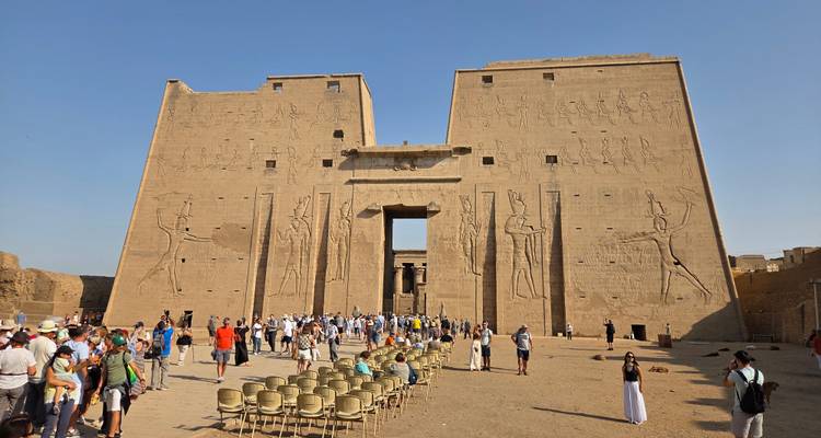 Large temple entrance with carvings and tourists.