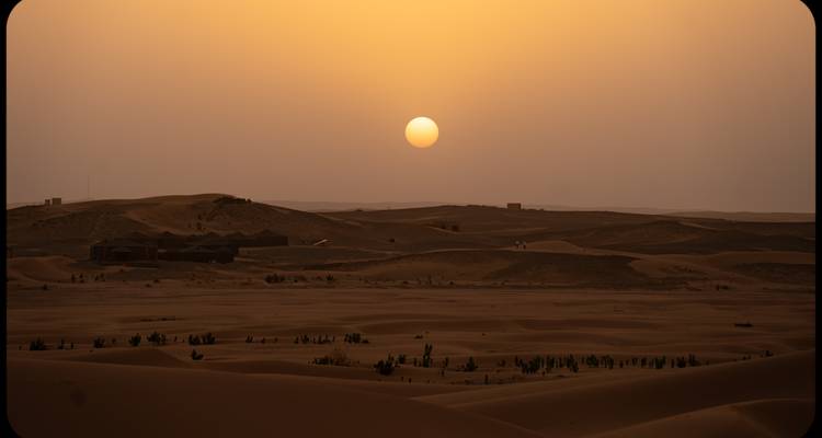 Sunset over a vast desert landscape.