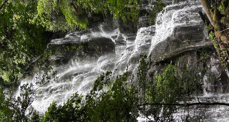 Waterfall cascading down a verdant landscape.