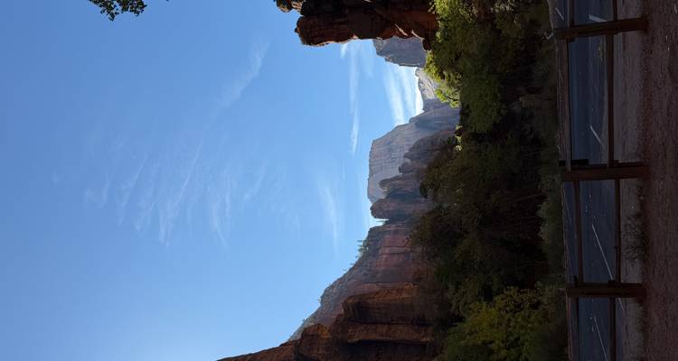 Scenic view of a canyon with towering cliffs against a clear blue sky.
