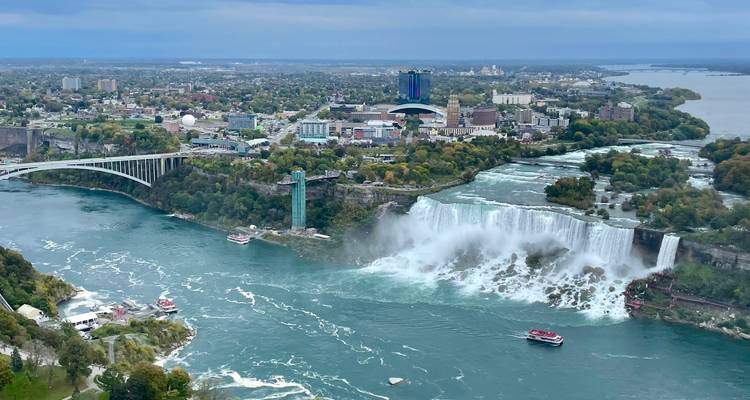 Aerial view of Niagara Falls with surrounding cityscape.