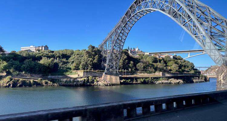 View of a large bridge over a river in Porto.