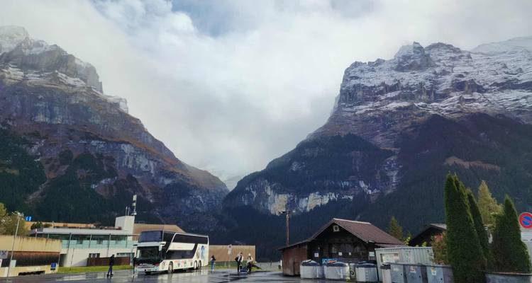 Mountainous landscape with buses in a valley setting.