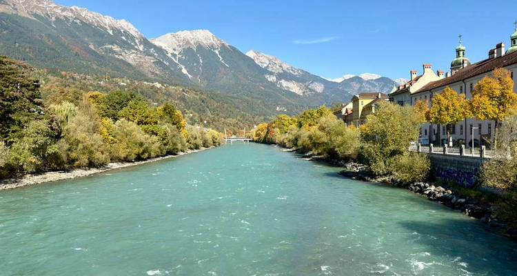 River with surrounding mountains and autumn trees.