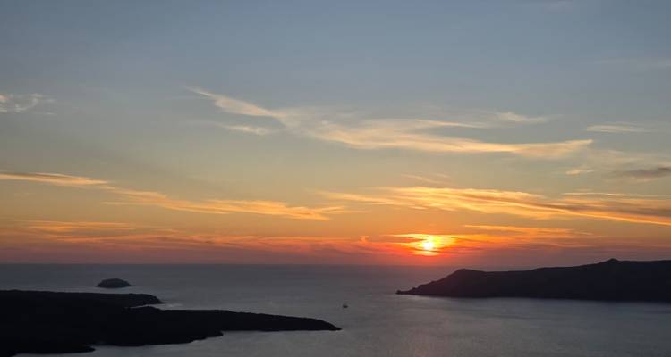 Sunset over the sea viewed from a cliff.