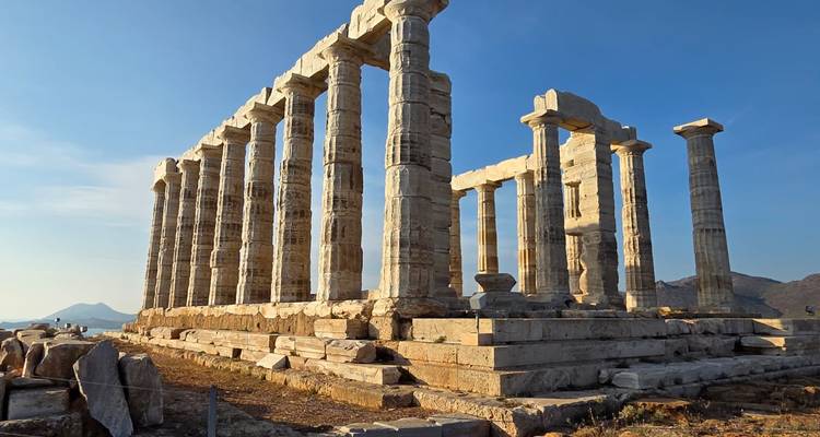 Ancient temple ruins with columns, sunny clear sky.