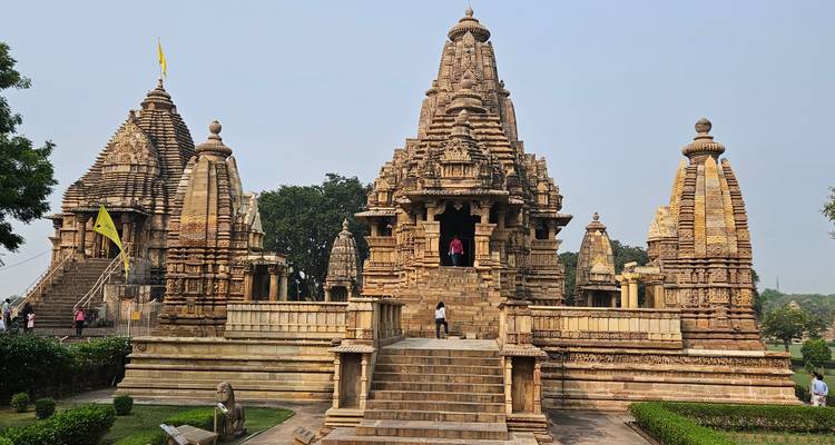 Khajuraho temple complex with visitors.