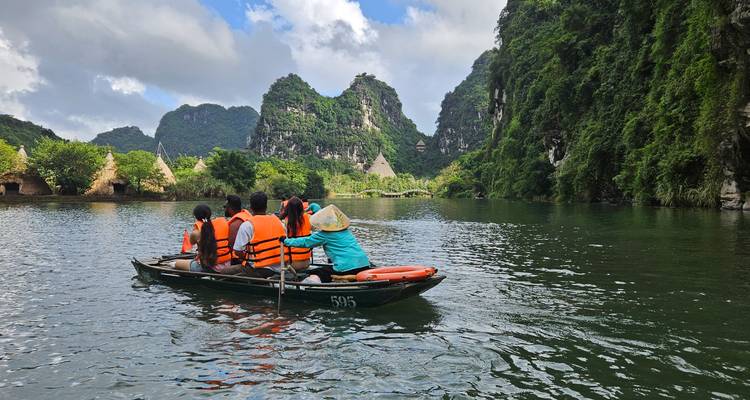 Tourists rowing boats on a scenic river surrounded by hills.