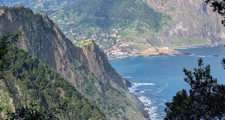 Une vue côtière avec des falaises et une petite ville en arrière-plan.