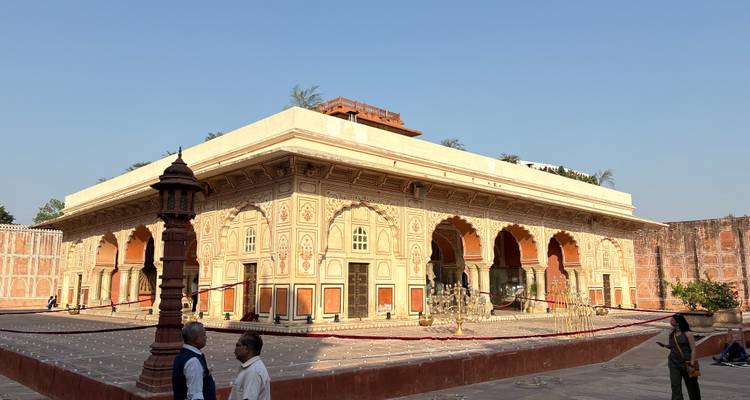 Ornate pink stone building in a historic complex.