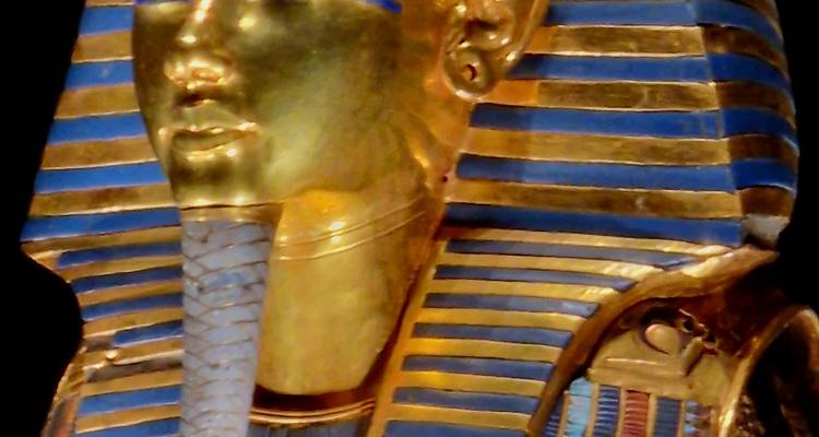 Image of a golden pharaoh mask with blue and gold stripes.