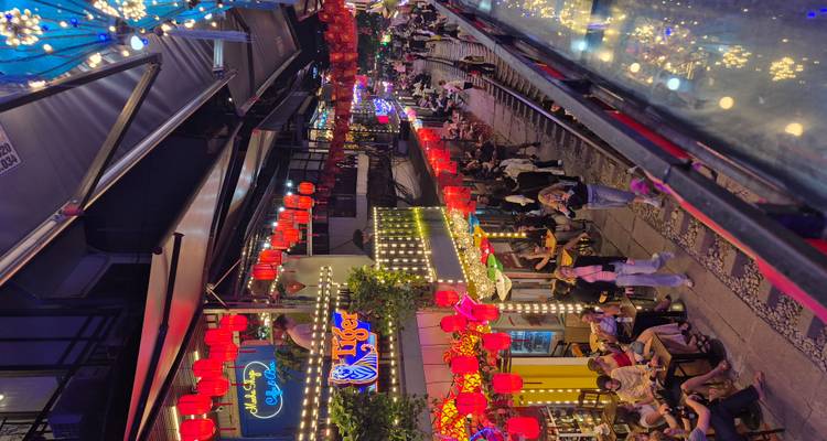 Een levendige straat in Hanoi met verlichte versieringen 's nachts.