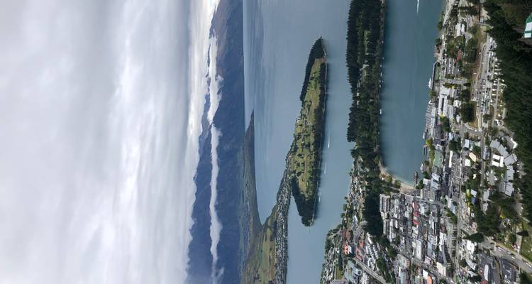 Town with lakeside views and surrounding mountains.