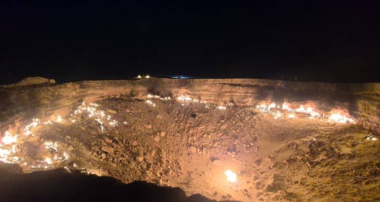 Burning crater with flames visible at night, known as the Gates of Hell.