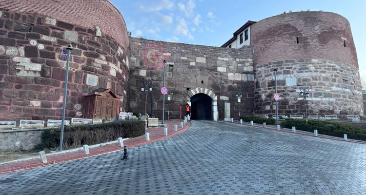 Puerta fortificada antigua con sendero de piedra.
