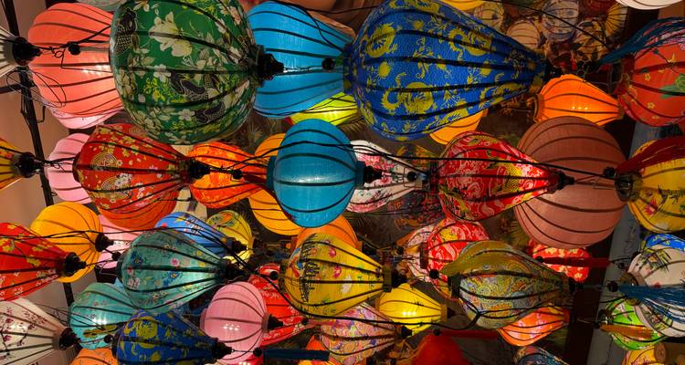 Brightly lit collection of multicolored Vietnamese lanterns hanging closely together