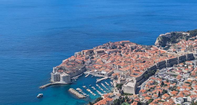 Stunning aerial panorama of Dubrovnik’s walled old town jutting into the deep blue Adriatic.