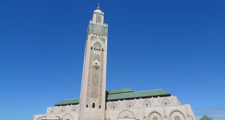 Hassan II Mosque with its tall minaret rising against a deep blue sky in Casablanca