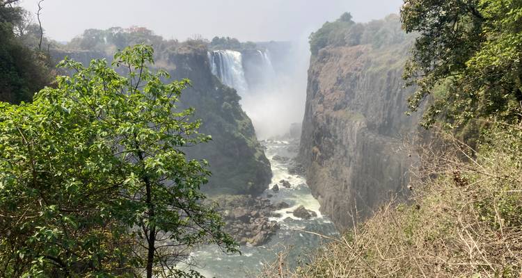 Spectacular view into the gorge of Victoria Falls with powerful water flowing between steep cliffs