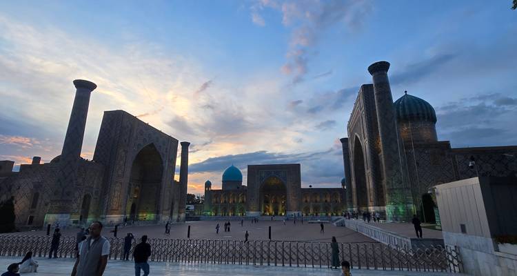 Evening light glows over Samarkand’s Registan square with its majestic blue domes and soaring portals.