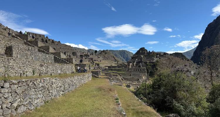 Repeat panoramic scene of Machu Picchu ruins beneath a brilliant Andean sky.