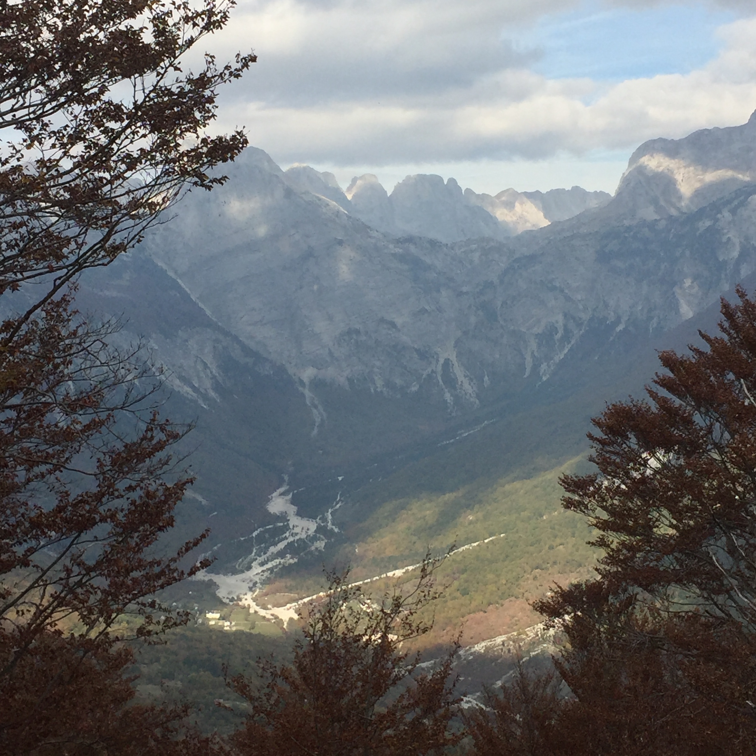 Mountain range with a valley and river below.