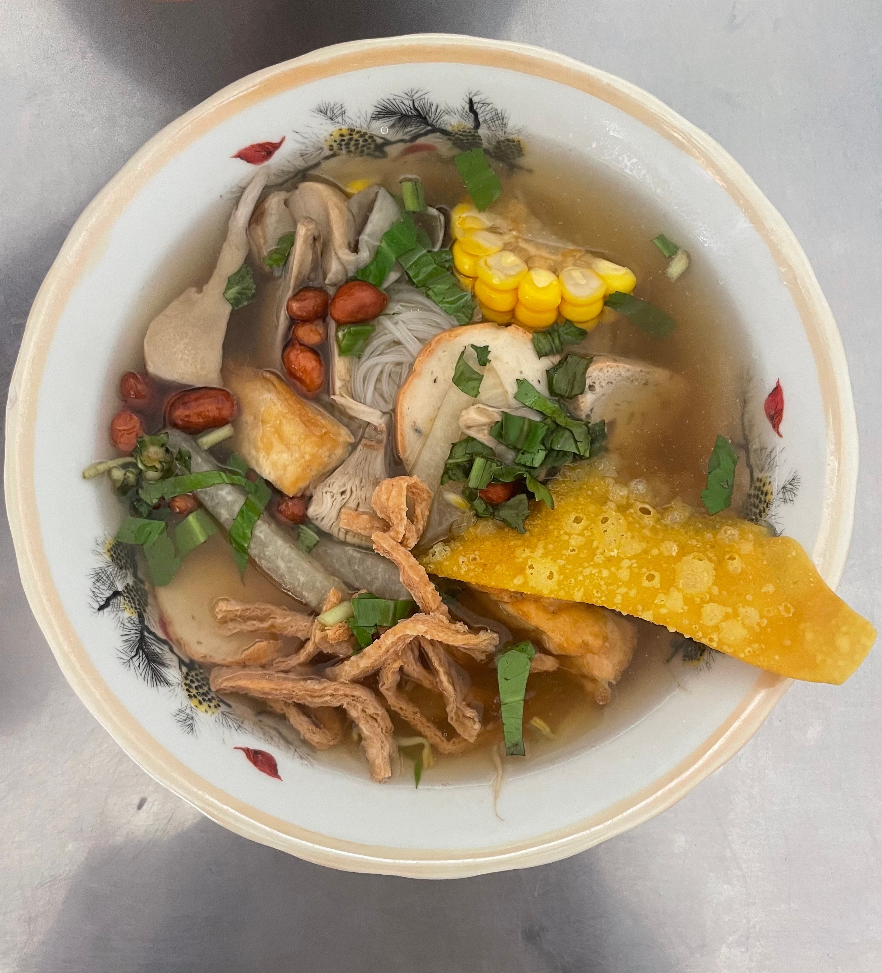 Bowl of Vietnamese noodle soup with ingredients.