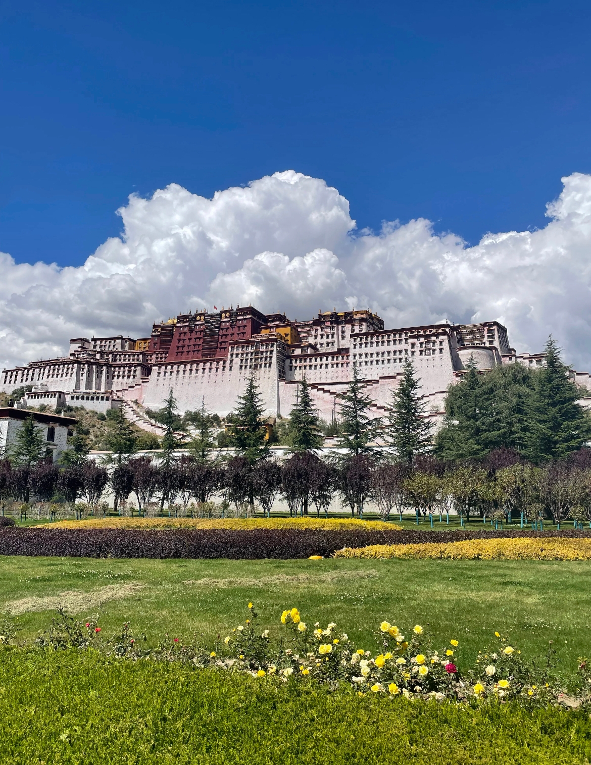 The Potala Palace in Lhasa, Tibet, under a cloudy sky.