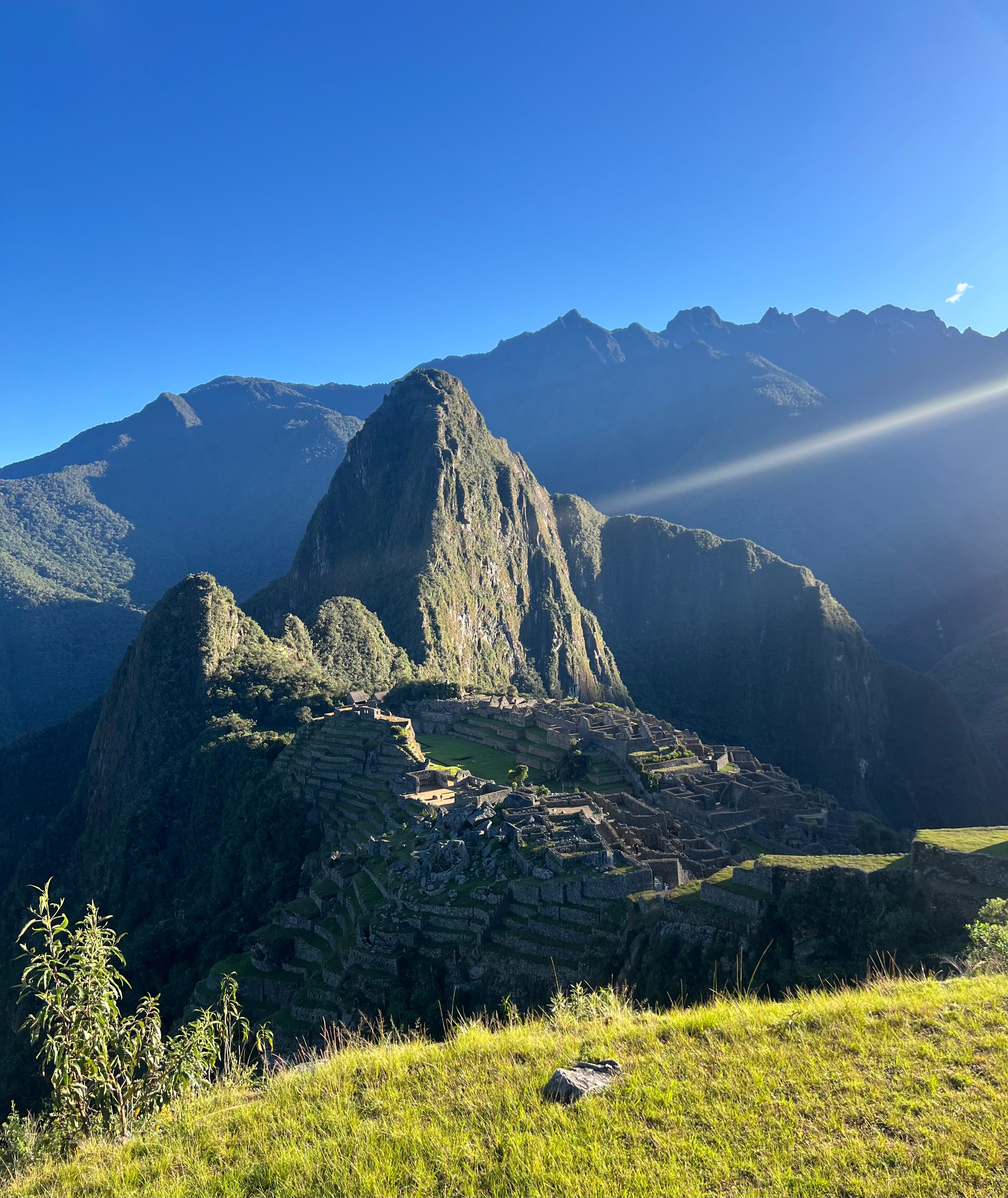 View of Machu Picchu with surrounding mountains.