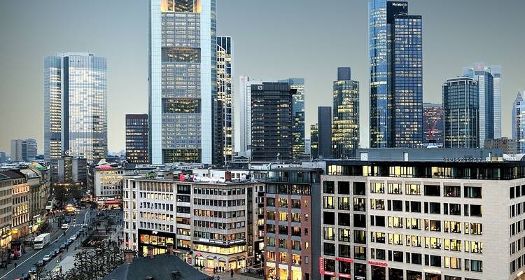 A cityscape featuring modern skyscrapers and busy streets below.