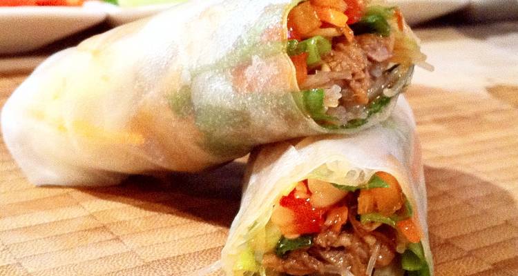 Close-up of fresh Vietnamese spring rolls filled with vegetables and meat.