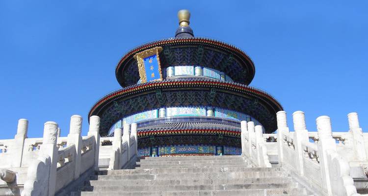 The ornate, circular Temple of Heaven rises against a clear blue Beijing sky.