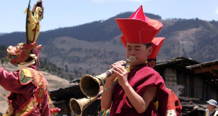 Bhutanese musician playing an instrument during a cultural performance.