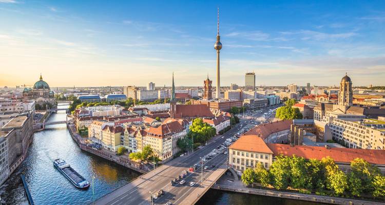 Sweeping golden-hour view of Berlin with the TV Tower above the meandering Spree River.